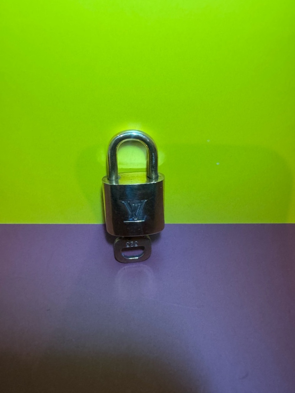 Louis Vuitton Silver Padlock on Two-Tone Backdrop